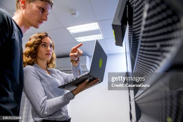 young it engineers working in supercomputer electricity backup room - backup stock pictures, royalty-free photos & images