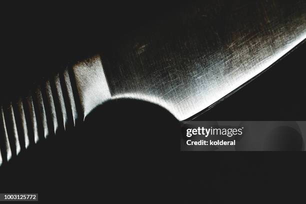 steel kitchen knife on black background - messerstecherei stock-fotos und bilder