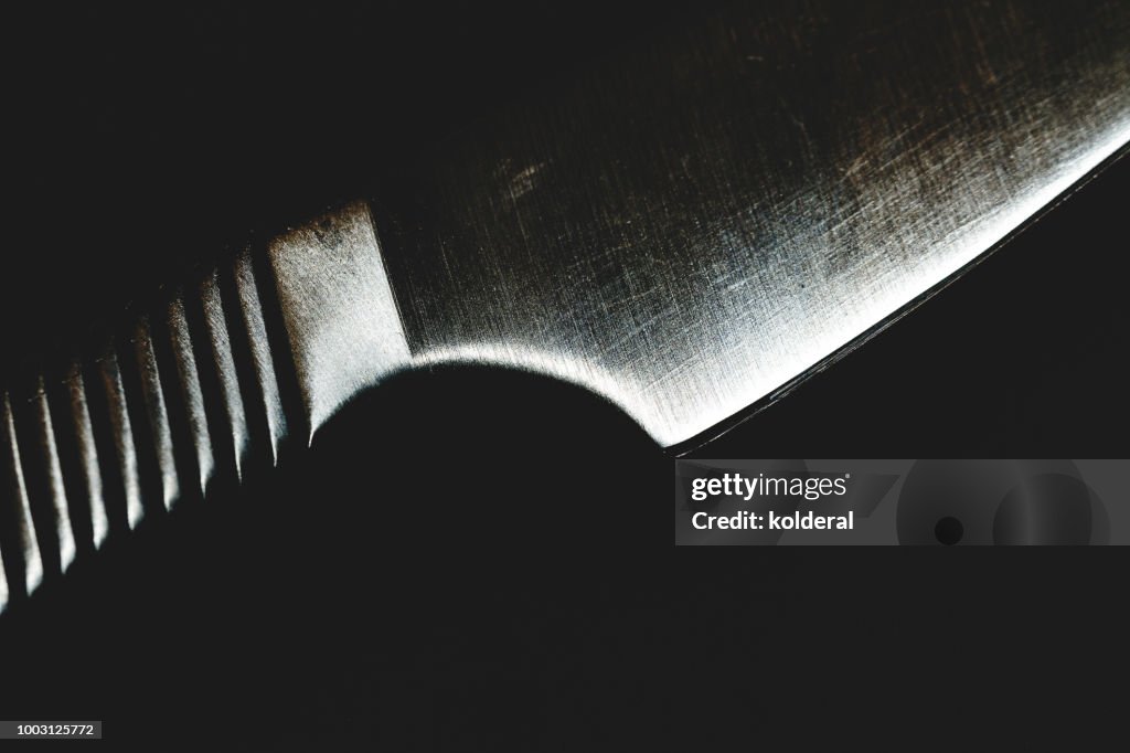 Steel kitchen knife on black background