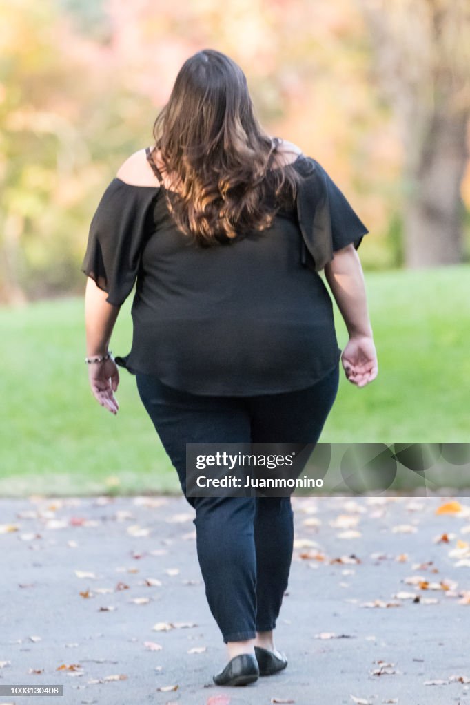 Overweight woman walking from behind