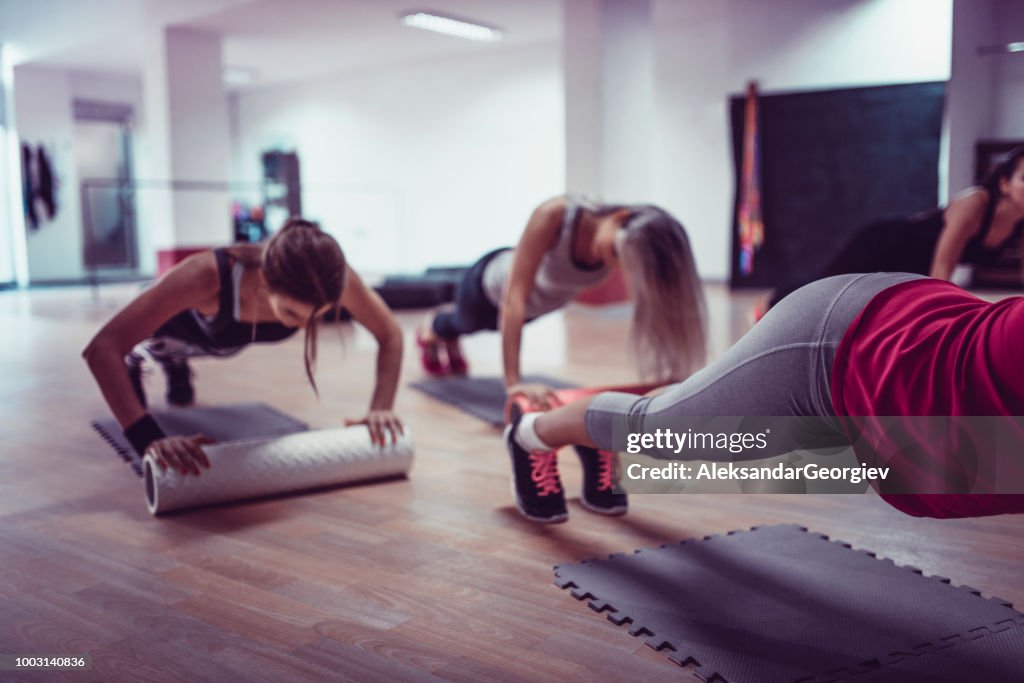 Female Athletes Working Out Together During Fitness Class In Gym