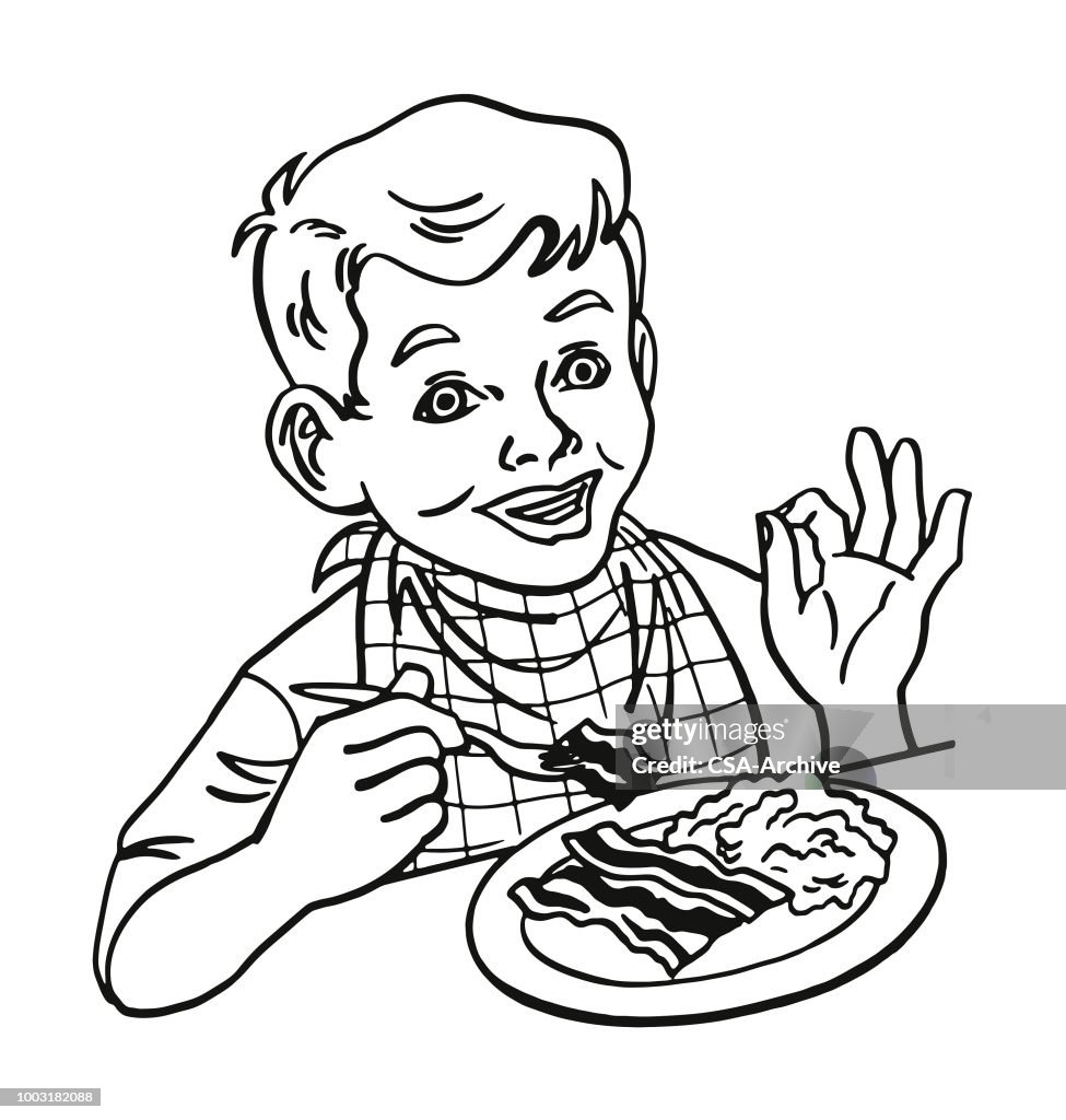 Boy Eating Scrambled Eggs and Bacon