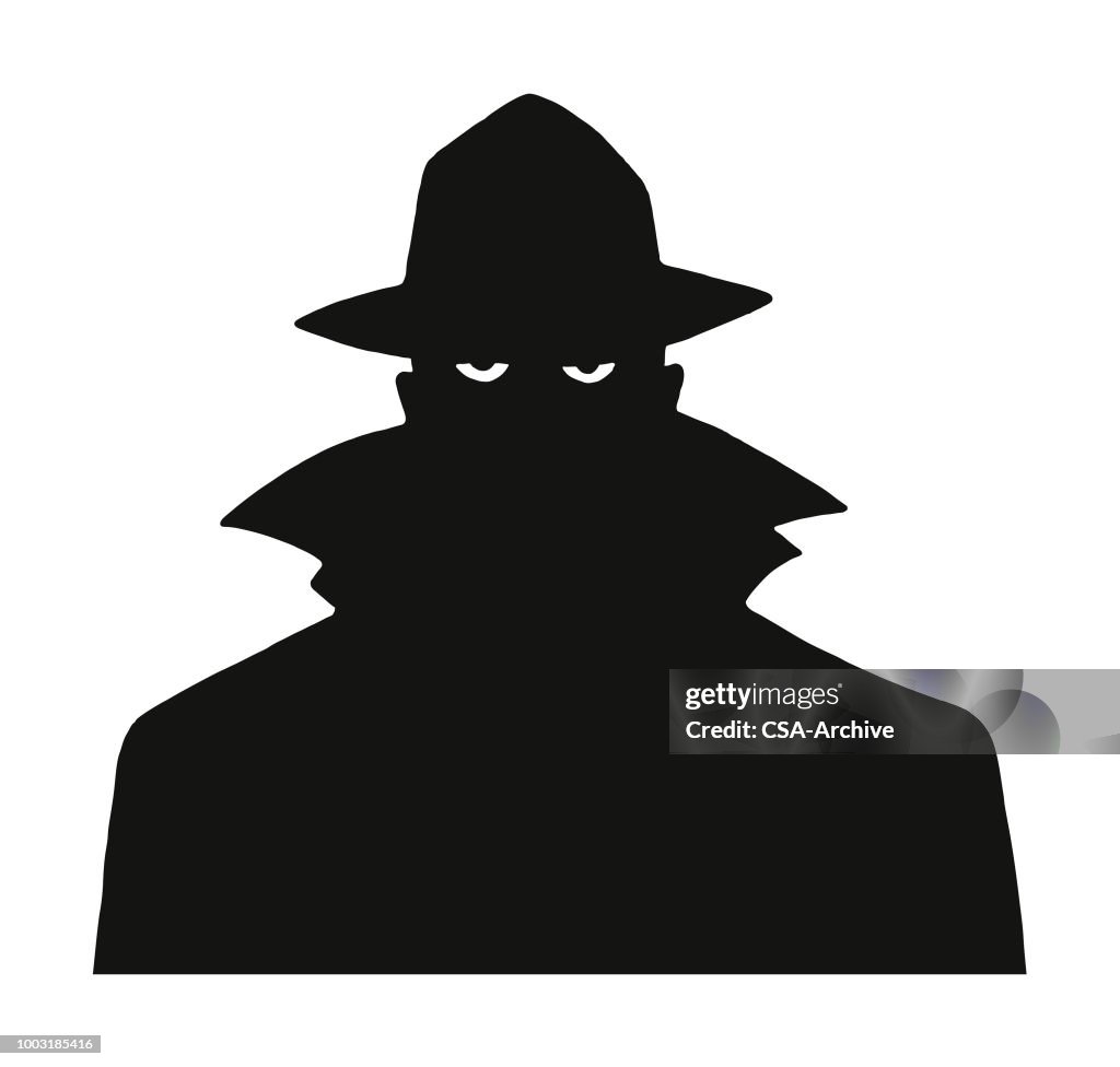 Silhouette of a Man in a Trench Coat and Hat