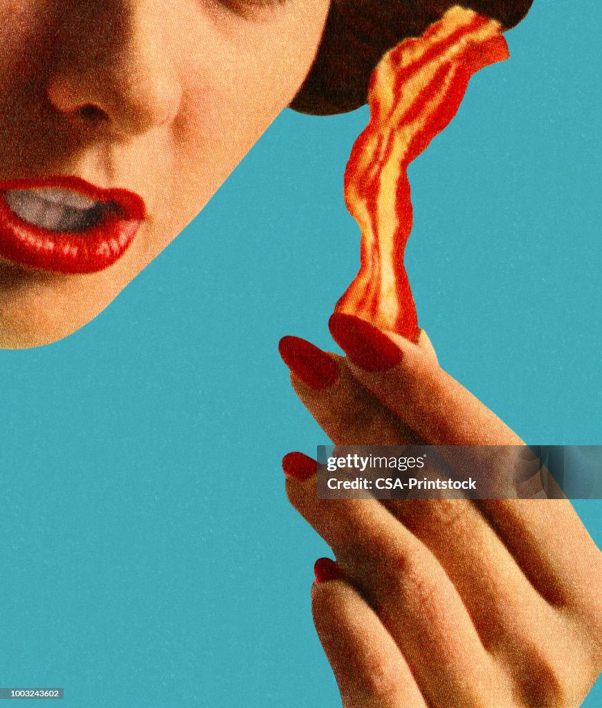 Woman Holding a Piece of Bacon