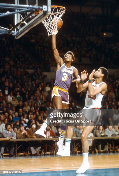 Elmore Smith of the Los Angeles Lakers goes in for a slam dunk over Kareem Abdul-Jabbar of the Milwaukee Bucks during an NBA basketball game circa...
