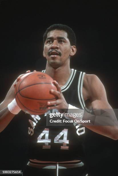 George Gervin of the San Antonio Spurs shoots a free throw against the Washington Bullets during an NBA basketball game circa 1984 at the Capital...