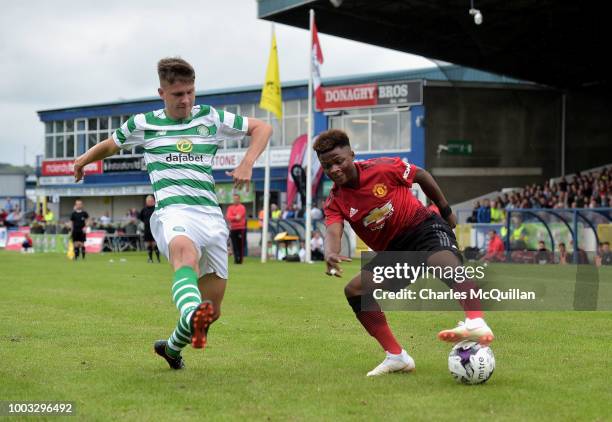 Largie Ramazani of Manchester United and Lewis Bell of Celtic during the u19 NI Super Cup gala match at Coleraine Showgrounds on July 21, 2018 in...