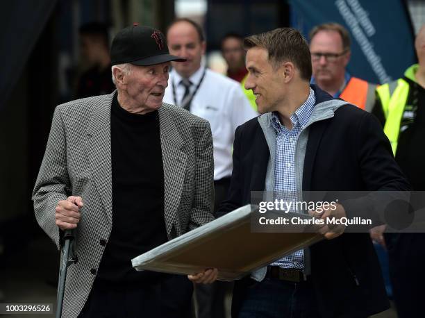 Former Manchester United players Phil Neville and Harry Gregg chat before the u19 NI Super Cup gala match between Manchester United and Celtic at...