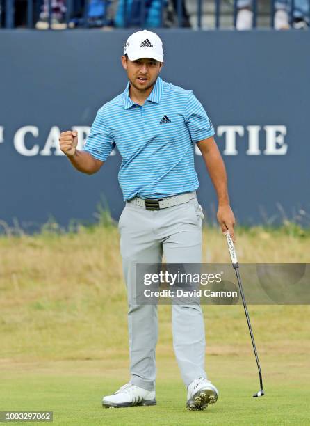 Xander Schauffele of the United States celebrates holing out on the 18th hole during the third round of the 147th Open Championship at Carnoustie...