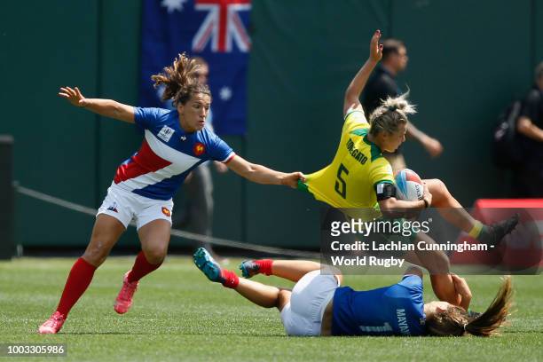 Emma Tonegato of Australia is tackled by Marjorie Mayans and Fanny Horta of France during their semi final on day two of the Rugby World Cup Sevens...