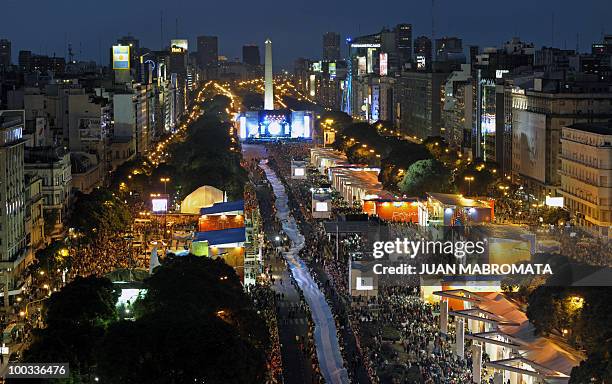 People hold a huge Argentine flag along 9 de Julio avenue, in Buenos Aires on May 22, 2010 as part of the celebrations for the Bicentenary of the May...