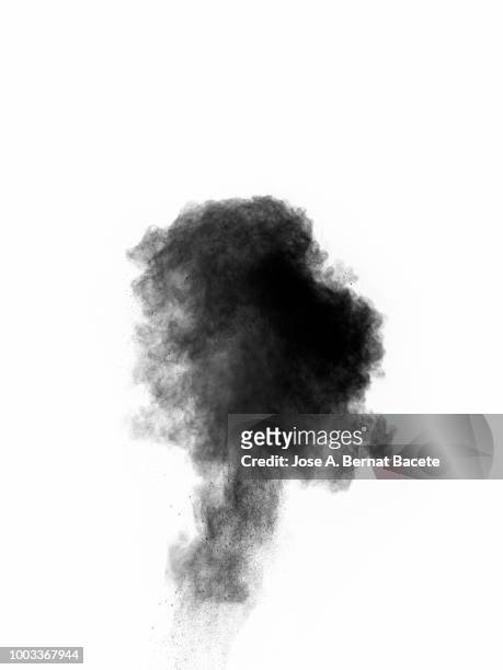 explosion by an impact of a cloud of particles of powder of color gray and black on a white background. - mushroom cloud stock pictures, royalty-free photos & images