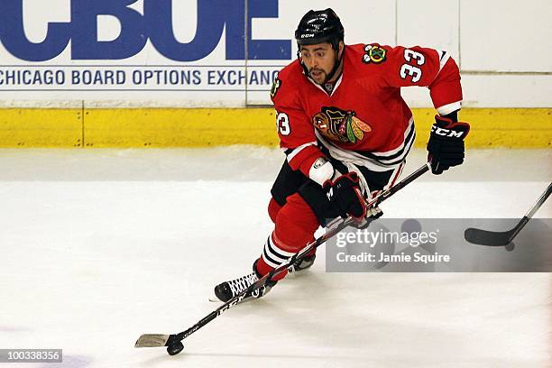 Dustin Byfuglien of the Chicago Blackhawks moves the puck while taking on the San Jose Sharks in Game Three of the Western Conference Finals during...