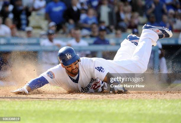 Matt Kemp of the Los Angeles Dodgers dives home to score a run against the Detroit Tigers during the fourth inning at Dodger Stadium on May 22, 2010...