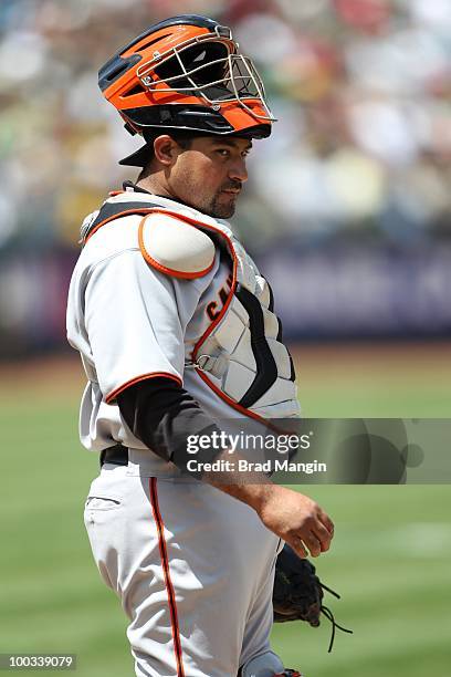 Bengie Molina of the San Francisco Giants takes a break behind the plate against the Oakland Athletics during the game at the Oakland-Alameda County...