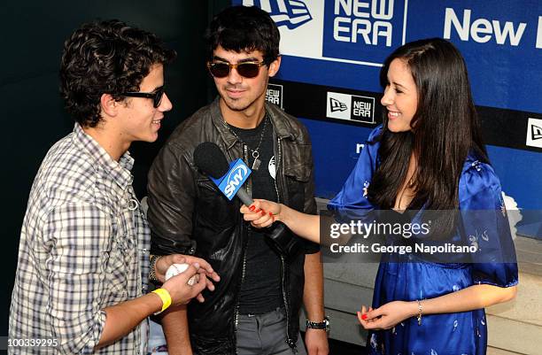 Nick Jonas and Joe Jonas talk to Julie Alexander from SNY at Citi Field on May 22, 2010 in New York City.