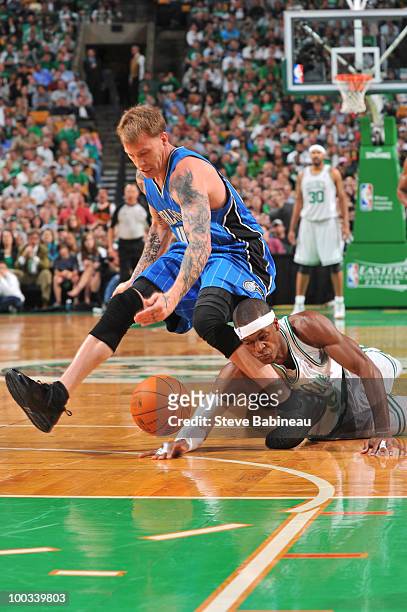 Rajon Rondo of the Boston Celtics dives for the ball against Jason Williams of the Orlando Magic in Game Three of the Eastern Conference Finals...