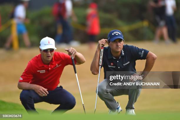 Golfer Kevin Kisner and US golfer Zach Johnson line up their putts on the 16th green during their third rounds on day 3 of The 147th Open golf...