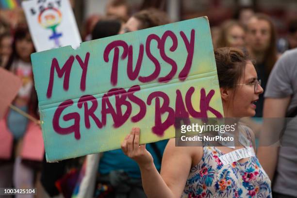Protestor holds sign saying 'My pussy grabs back' referring to Donald Trump. Some 500 people demonstrated through the streets of Munich to protest...