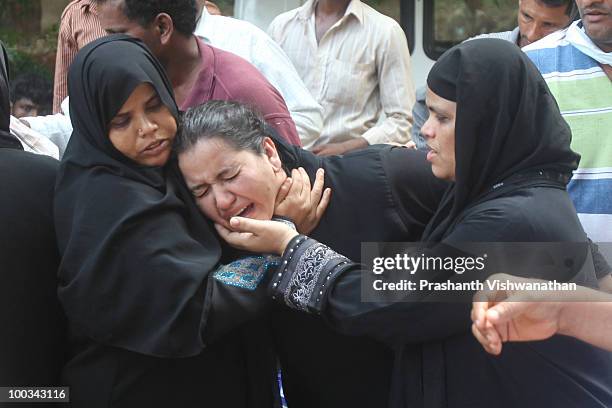Relatives of deceased passengers break down outside a mortuary, after identifying their family members on May 23, 2010 in Mangalore. An Air India...