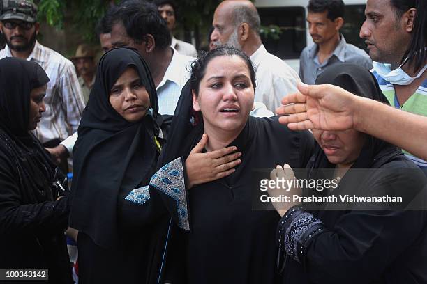 Relatives of deceased passengers break down outside a mortuary, after identifying their family members on May 23, 2010 in Mangalore. An Air India...