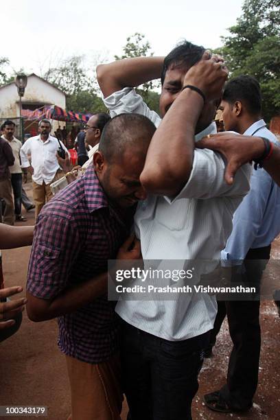 Relatives of deceased passengers break down outside a mortuary, after identifying their family members on May 23, 2010in Mangalore. An Air India...