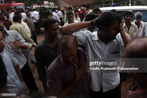 Relatives of deceased passengers break down outside a mortuary, after identifying their family members on May 23, 2010in Mangalore. An Air India...