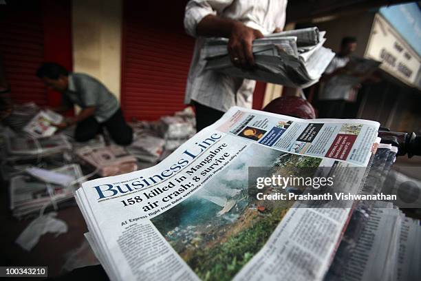 Newspapers detail the news of the air crash on May 23, 2010 in Mangalore. An Air India Express Boeing 737-800 series aircraft arriving from Dubai,...