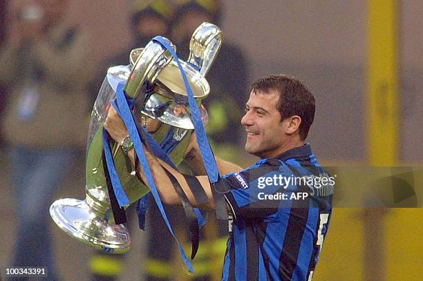 Inter Milan's Serbian midfielder Dejan Stankovic shows the Champions League Trophy to their supporters at San Siro stadium in Milan after their...