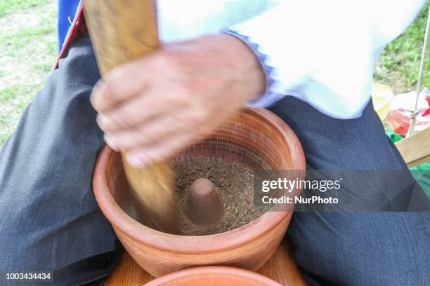 Kashub man grinding tobacco in a traditional way to obtain snuff is seen in Chmielno, Kashubia region, Poland on 21 July 2018 Kashubs or Kashubians...