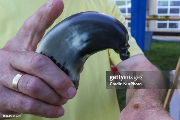 Man taking snuff from traditional Kashubian snuff box made of cow horn is seen in Chmielno, Kashubia region, Poland on 21 July 2018 Kashubs or...