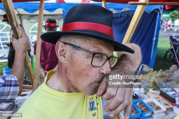 Man taking snuff from traditional Kashubian snuff box made of cow horn is seen in Chmielno, Kashubia region, Poland on 21 July 2018 Kashubs or...