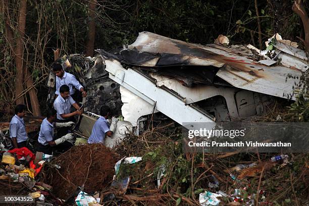 Directorate General Civil Aviation officers inspect the plane crash site on May 23, 2010 in Mangalore. An Air India Express Boeing 737-800 series...