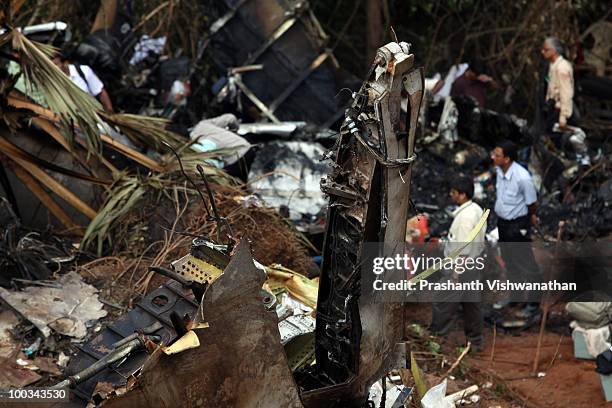 Directorate General Civil Aviation officers inspect the plane crash site on May 23, 2010 in Mangalore. An Air India Express Boeing 737-800 series...