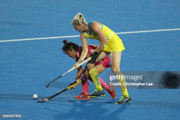 Motomi Kawamura of Japan steals the ball from Jodie Kenny of Australia during the Pool D game between Australia and Japan of the FIH Womens Hockey...