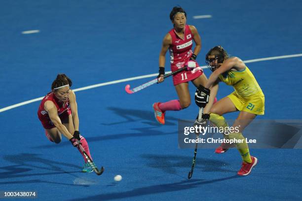 Hazuki Nagai of Japan shoots past Renee Taylor of Australia during the Pool D game between Australia and Japan of the FIH Womens Hockey World Cup at...