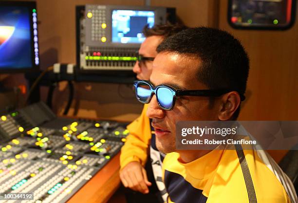 Lucas Neill and Tim Cahill of the Socceroos watch their training session in 3-D in the Fox Sports broadcast van after an Australian Socceroos...