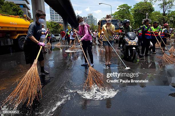 Hundreds of Bangkok residents participate in a Bangkok Clean Up day sweeping up the streets with soap and water May 23, 2010 in Bangkok, Thailand. A...