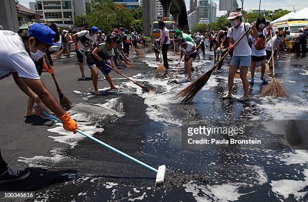 Hundreds of Bangkok residents participate in a Bangkok Clean Up day sweeping up the streets with soap and water May 23, 2010 in Bangkok, Thailand. A...