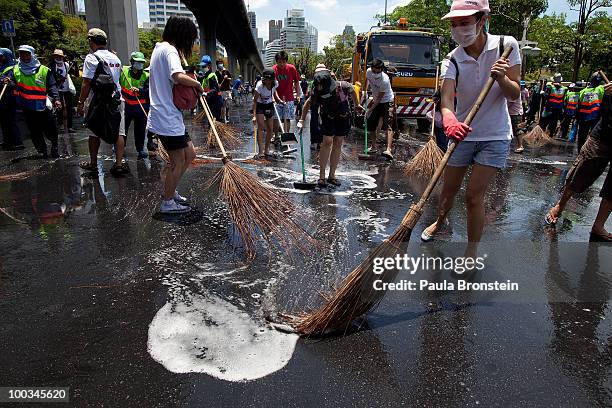 Hundreds of Bangkok residents participate in a Bangkok Clean Up day sweeping up the streets with soap and water May 23, 2010 in Bangkok, Thailand. A...