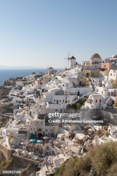 Traditional houses at Oia caldera with wonderful views to the sea caldera and volcano on July 16, 2018 in Santorini, Greece.