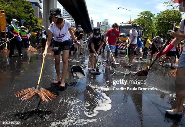 Hundreds of Bangkok residents participate in a Bangkok Clean Up day sweeping up the streets with soap and water May 23, 2010 in Bangkok, Thailand. A...