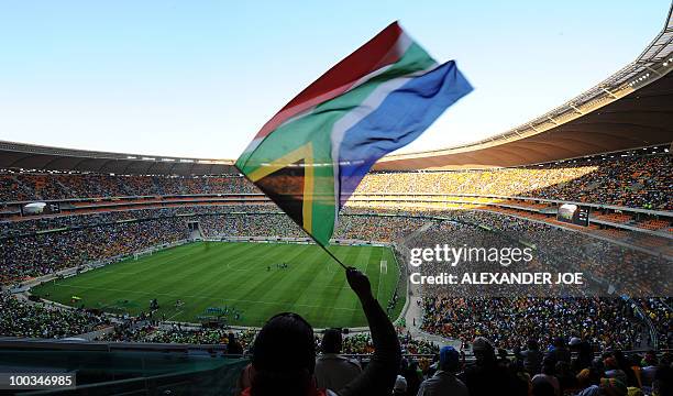 Football's fans cheer in Soccer City in Soweto on May 22, 2010 during a local soccer game. The match is played in the stadium that willl host the...