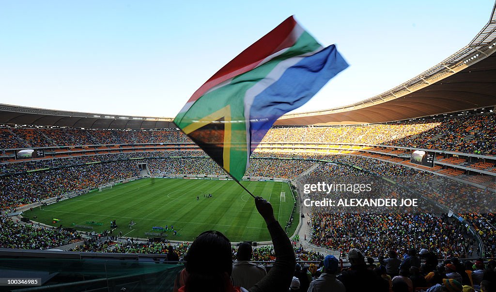 Football's fans cheer in Soccer City in