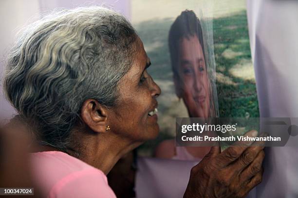 The grand mother of an Air India Express crash victim mourns over the photograph on the coffin of her granddaughter H. Goldine, during a funeral...