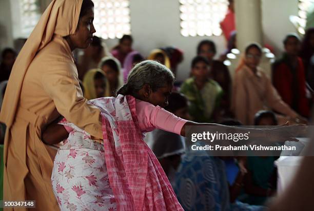 The grand mother of an Air India Express crash victim mourns her granddaughter H. Goldine, during a funeral service at the St. Alphonsa Catholic...