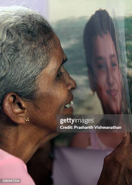 The grand mother of an Air India Express crash victim mourns over the photograph on the coffin of her granddaughter H. Goldine, during a funeral...