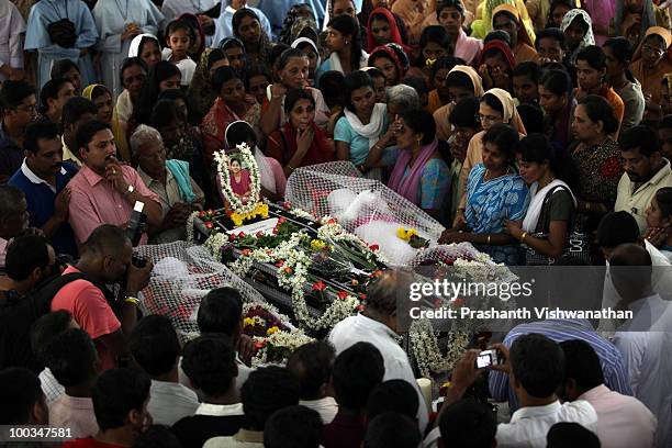 Mourners attend the funeral of H.Rosaline and her two daughters H.Goldine and H.Gloria, victims of the Air India Express plane crash, at the St....