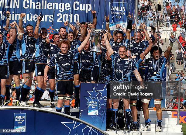 Gethin Jenkins , the Cardiff captain raises the trophy with Paul Tito as their team celebrate victory during the Amlin Challenge Cup Final between...