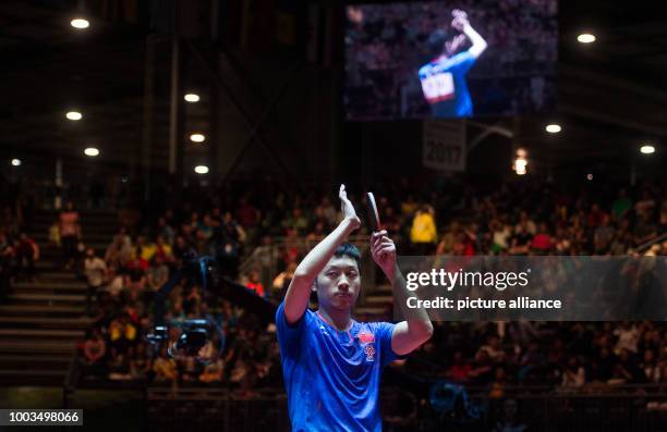 Xu Xin thanks his fans after his match against Gaoyuan during the men's single round of sixteen at the Table Tennis World Championship in...